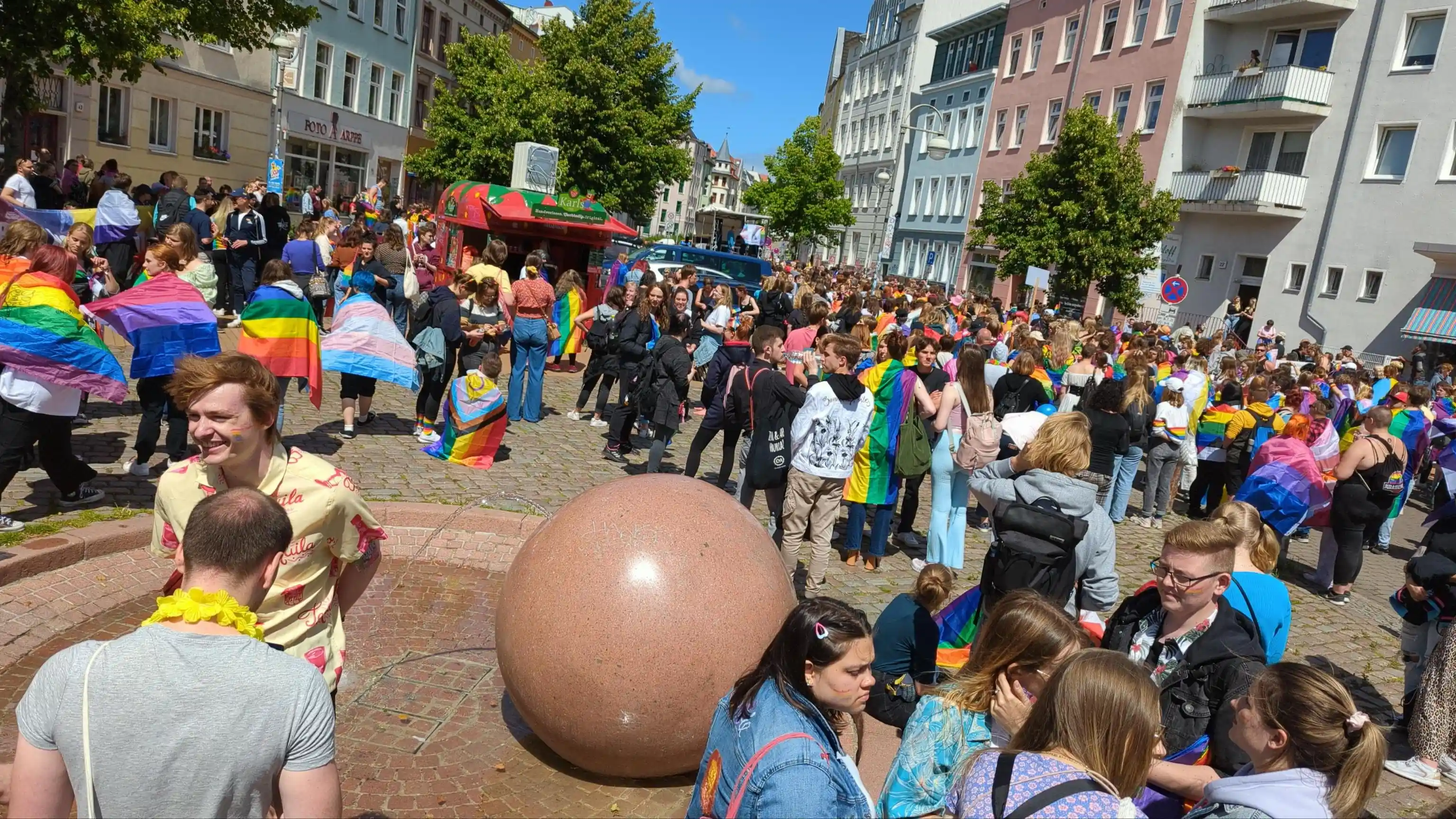 Rainbow people standing on a square